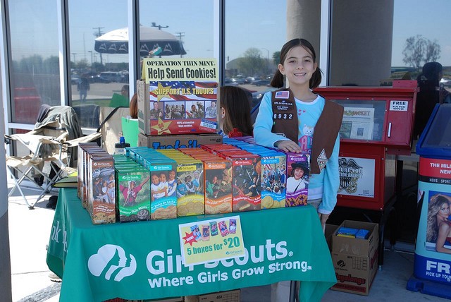 A Girl Scout proudly displaying her correctly named cookies.